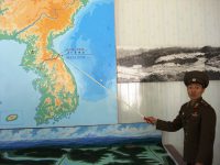 North Korean Soldier showing border between North and South Korea.