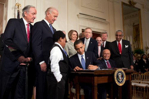 President Obama signs the Affordable Care Act.