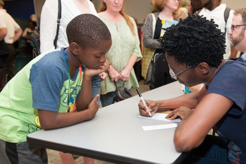 Jacqueline Woodson signs a book for a fan.