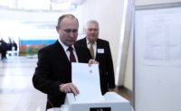 President Vladimir Putin votes in yesterday's presidential election.