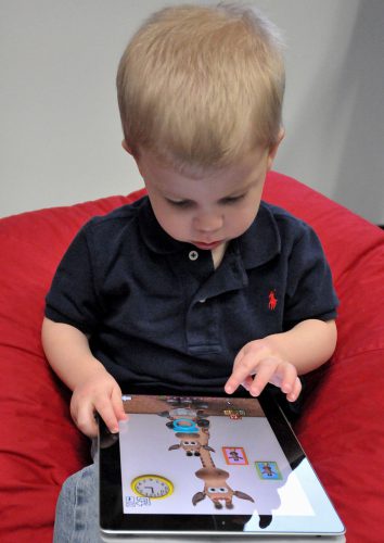 Young child using an iPad.