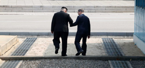 President Moon Jae-in and Kim Jong-un, the leader of North Korea, step across the border between the two countries.