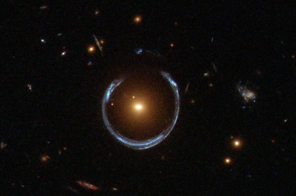 An "Einstein Ring" - the red galaxy, which is closer, bends the light from the blue galaxy, which is farther away.
