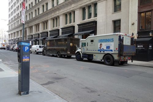 A Brink's armored truck and a UPS truck parked in Manhattan.