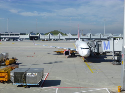 Plane with boarding ramp attached.