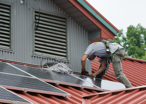 Installing solar panels on a roof.