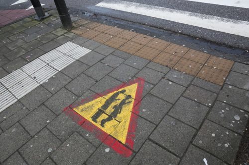 Sign warning walkers to look up as they cross they road, Amsterdam.