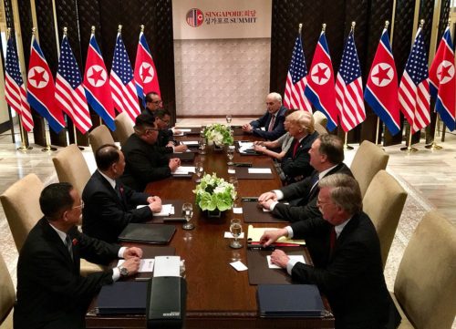 Mr. Trump and Mr. Kim meeting with teams of helpers.