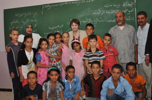 Nouria Benghabrit (back, center) is in charge of education in Algeria.In this picture, she is visiting a primary school.