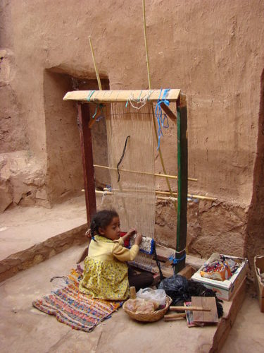 Young girl weaving in Morocco.