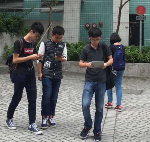 People staring at their smartphones while walking.