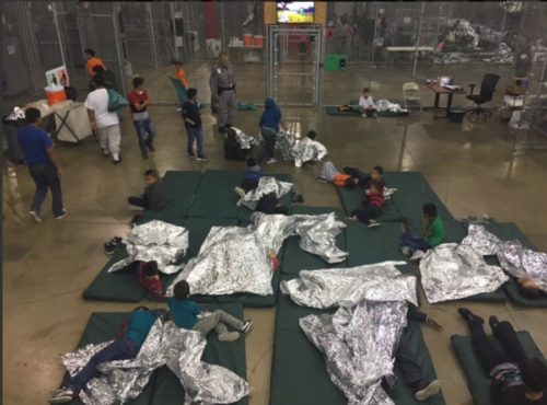 The US government is keeping some of the children in large cages in a big building.