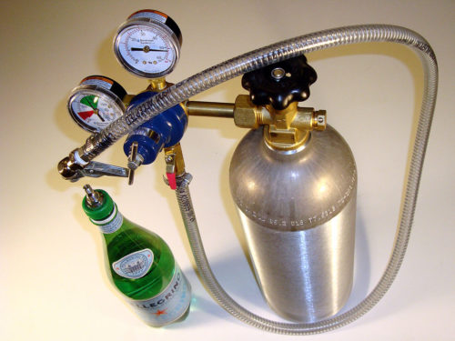 Carbon dioxide is usually stored in tanks like the one below.The gas is then added to drinks.