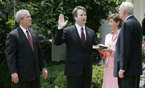 Kennedy swears Kavanaugh in with Bush looking on.