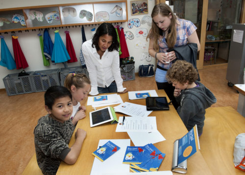 Students using tablets as part of a lesson.