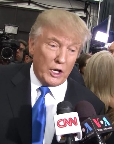 Mr. Trump speaking into CNN and VOA microphones.