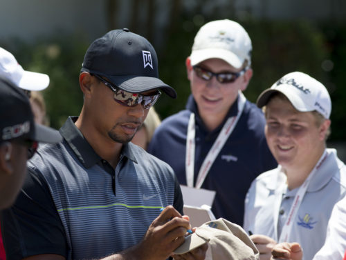 Tiger Woods signs autographs at the Quicken Loans National golf tournament at Congressional Country Club on June 24, 2014 in Bethesda, Maryland