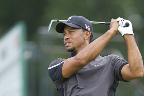 Tiger Woods watches the ball after finishing his swing. 2013