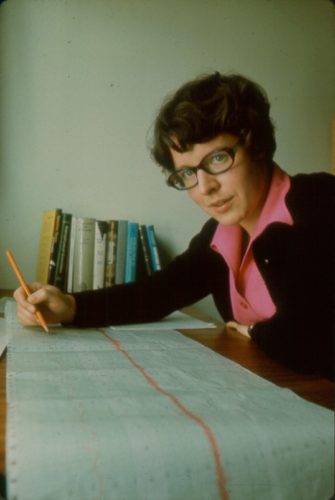 Dr. Jocelyn Bell Burnell studying a long paper chart.