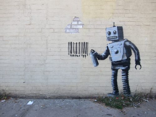 Graffiti of a robot spray painting a graffiti of a bar code from Banksy's "Better Out Than In" October 2013 New York City residency.