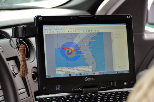 From their car, rescue workers track the storm as it comes close to land.