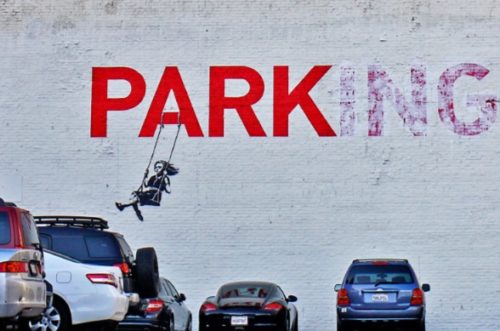 Banksy turned this "Parking" sign into a sign that simply said "Park" and showed a girl on a swing.