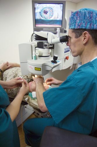 Capt. Joseph Pasternak, an ophthalmology surgeon at National Naval Medical Center Bethesda, lines up the laser on Marine Corps Lt. Col. Lawrence Ryder's eye before beginning LASIK IntraLase surgery.