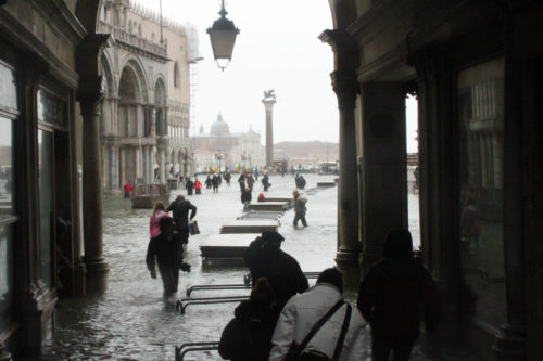 Raised platforms being set up during a flood in Venice.