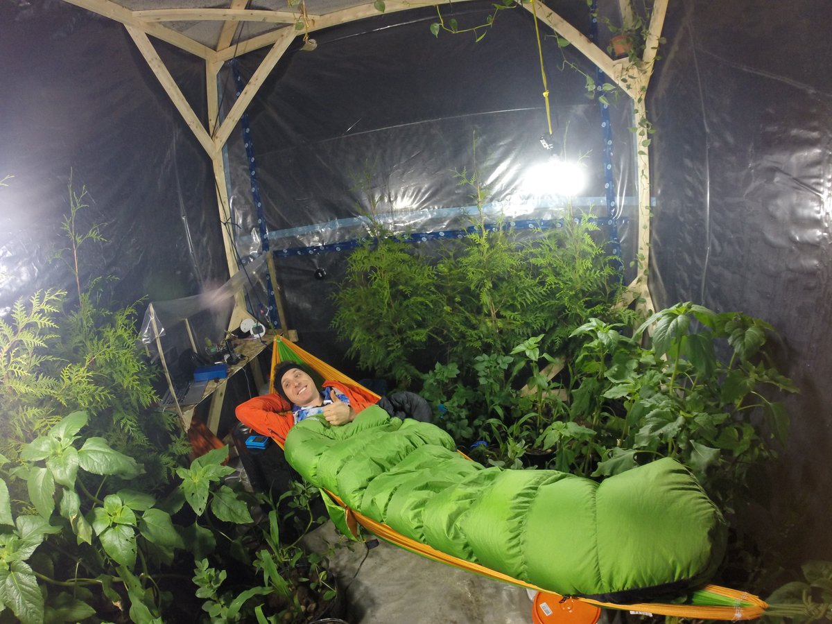 Mr. Baute in a sleeping bag inside his cube at night.