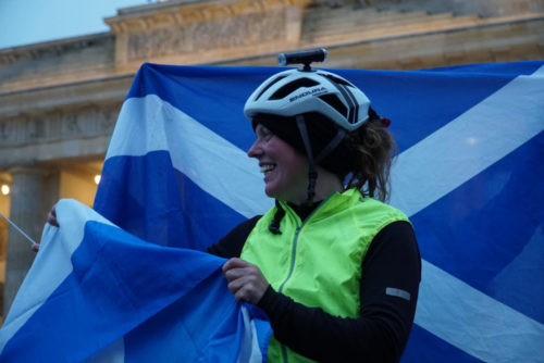 Jenny Graham with flag at the Brandenburg Gate