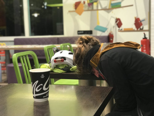 Ms. Graham asleep with her head down on the table in McDonald's.