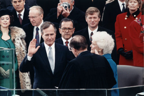 Chief Justice William Rehnquist administering the oath of office to President George H. W. Bush during Inaugural ceremonies at the United States Capitol. January 20, 1989.