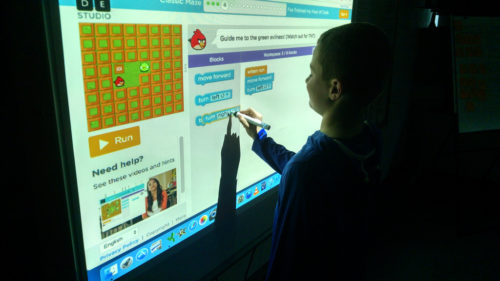 Student solving Angry Birds challenge on SmartBoard.