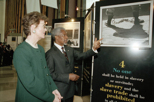 Secretary-General Kofi Annan points out display illustrating Article 4 of the Universal Declaration of Human Rights to Mary Robinson (left), United Nations High Commissioner for Human Rights. The display is part of an exhibit produced by the Department of Public Information (DPI) in the Visitors Lobby at Headquarters. Its opening coincides with the fiftieth anniversary of the Declaration.