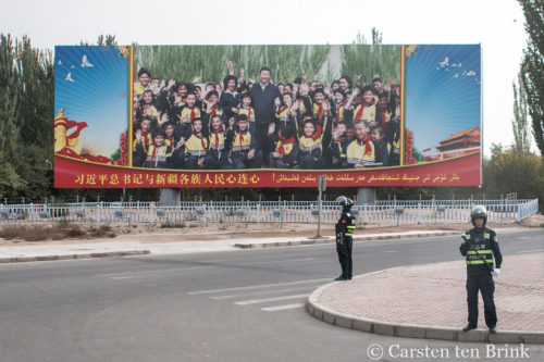 Xi Jingping billboard, police on curb.