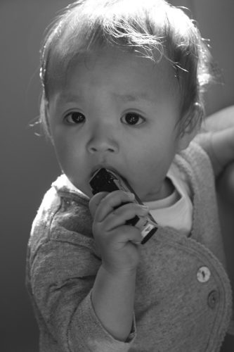 Human baby with a toy in his/her mouth