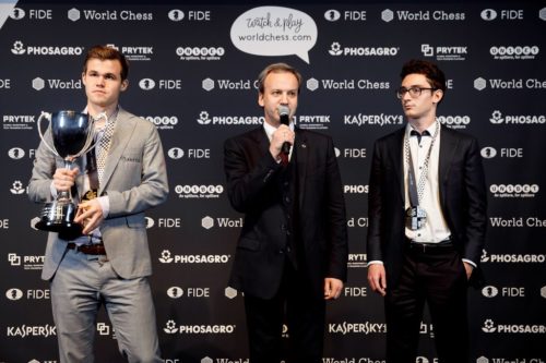 Magnus Carlsen (left, with trophy) and Fabiano Caruana with awards after the world chess championships.