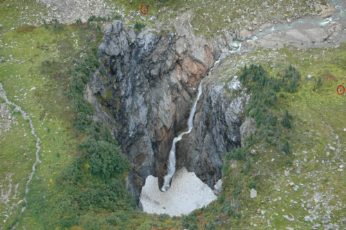 Aerial view showing waterfall down into the cave.