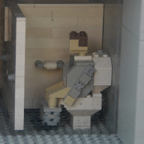 Lego figure on Lego toilet.