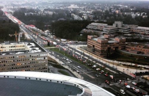 High atop some anonymous modern glass structure gazing out at the evening commute.