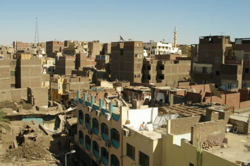 Massive construction of brick buildings, some lived in with roofs still open