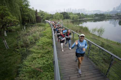 Mina Guli runs with school kids through Chongqing city, China, during the 6 River Run expedition, on the 11th April 2017