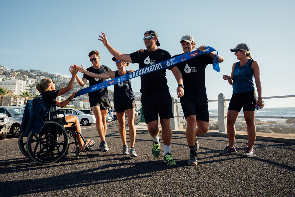 Ultra runner and water campaigner, Mina Guli celebrates her support team finishing a marathon in Cape Town, South Africa during the #RunningDry Expedition, on 5 January 2019