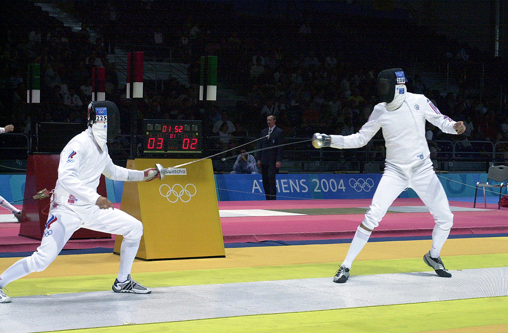 U.S. Air Force 2nd Lt. Weston Kelsey (right) fences for advancement against Russian Igor Tourchine (left) in the second round of the Olympic Men's Individual Epee event at the Helliniko Fencing Hall just outside Athens, Greece, on Aug. 17, 2004. This was Kelsey's first Olympic attempt and he did not advance to the third round.