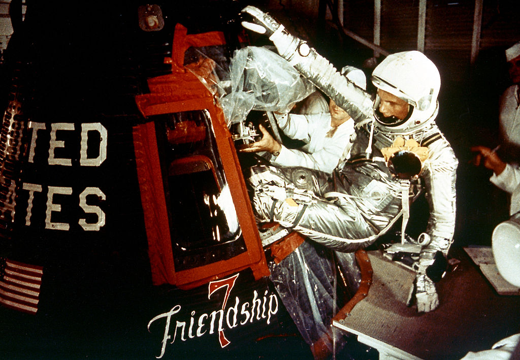 Astronaut John Glenn enters the Mercury spacecraft, Friendship 7, prior to the launch of MA-6 on February 20, 1962 and became the first American who orbited the Earth. The MA-6 mission was the first manned orbital flight, and lasted for five hours, orbiting the Earth three times.