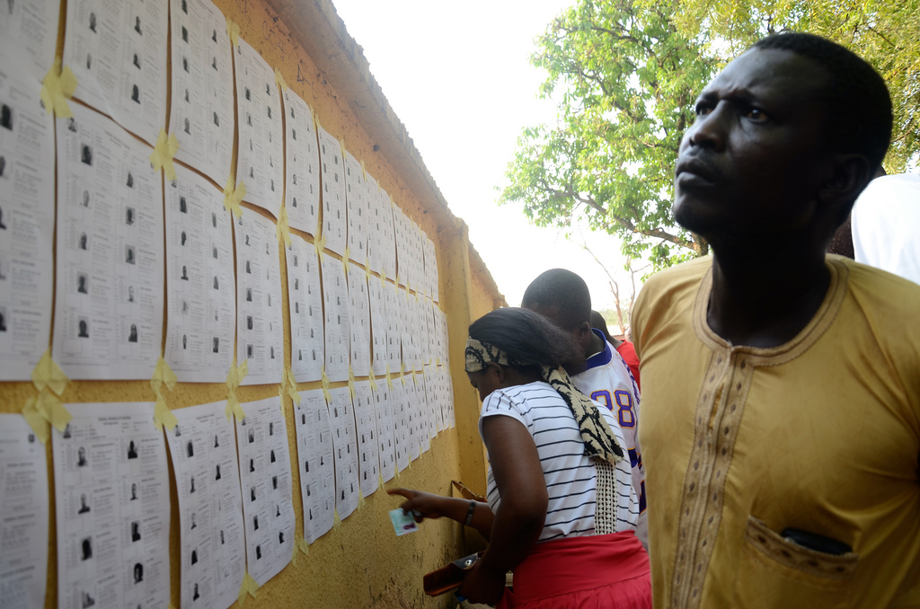 The Commonwealth Observer Group, chaired by the former President of the United Republic of Tanzania Jakaya Kikwete, witnessed the general elections in Nigeria. Voters look for information about candidates on a bulletin board.