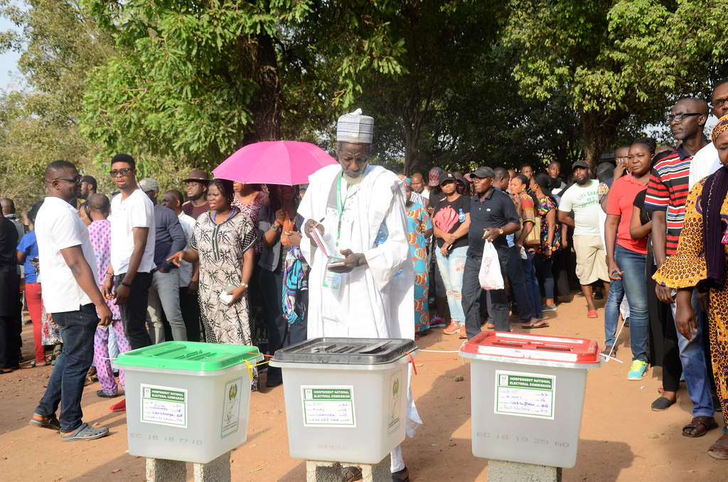 The Commonwealth Observer Group, chaired by the former President of the United Republic of Tanzania Jakaya Kikwete, witnessed the general elections in Nigeria. A man votes as others wait in lines.
