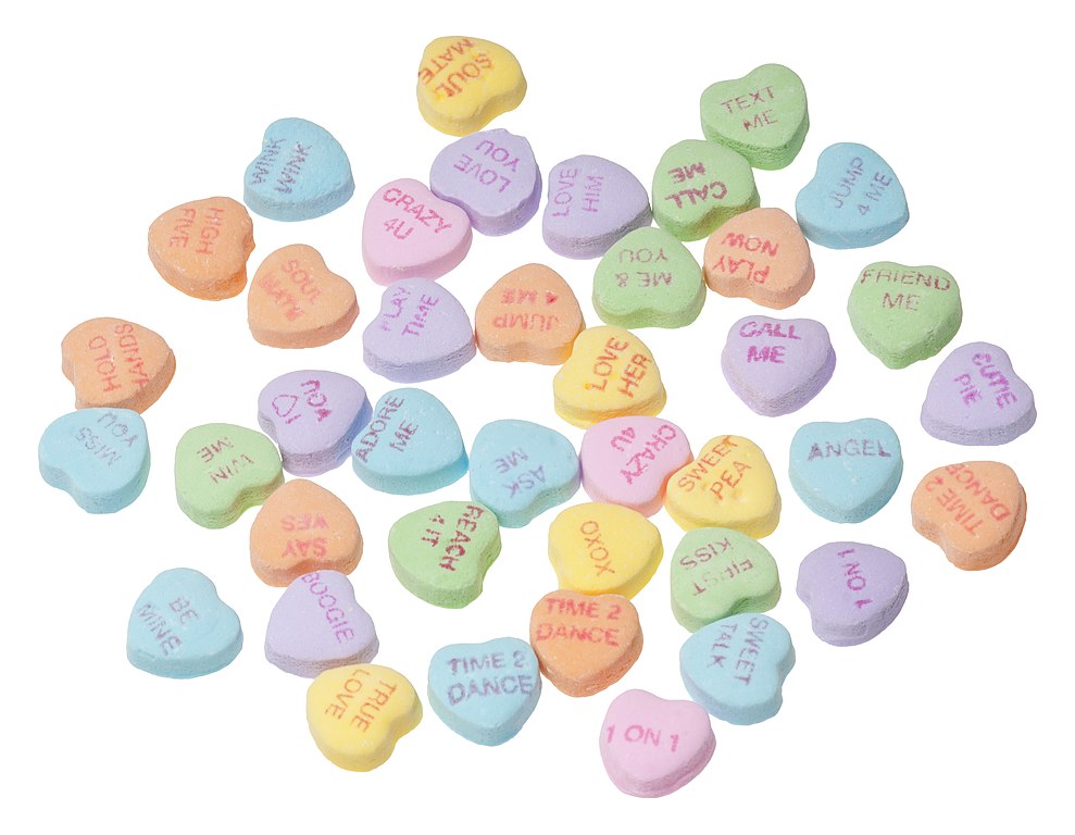 An array of Necco Sweethearts (conversation hearts). Little, chalky pieces of candy with phrases written on them; available around Valentine's Day.