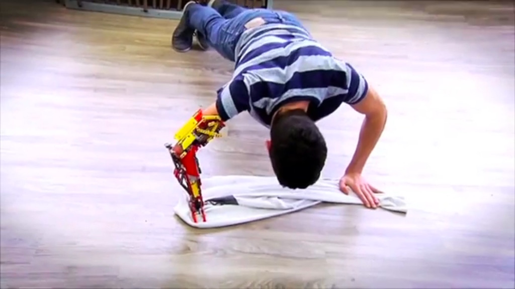 David Aguilar does a pushup with his Lego arm, the MK-I.