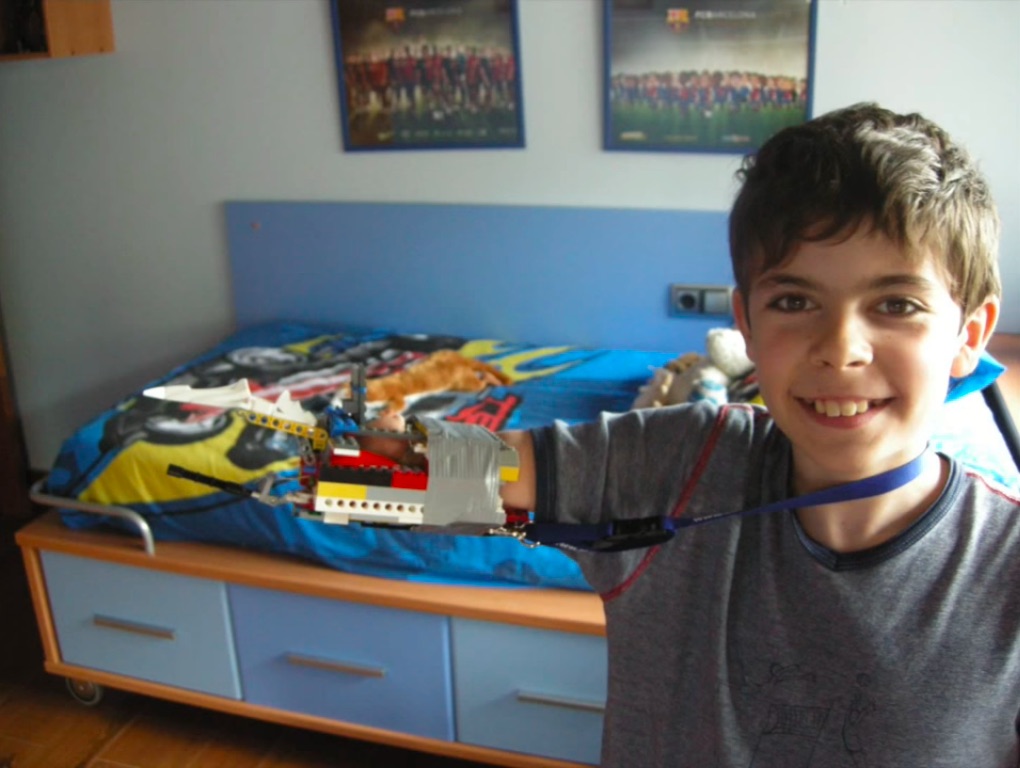 David Aguilar poses with the Lego arm he made when he was nine.